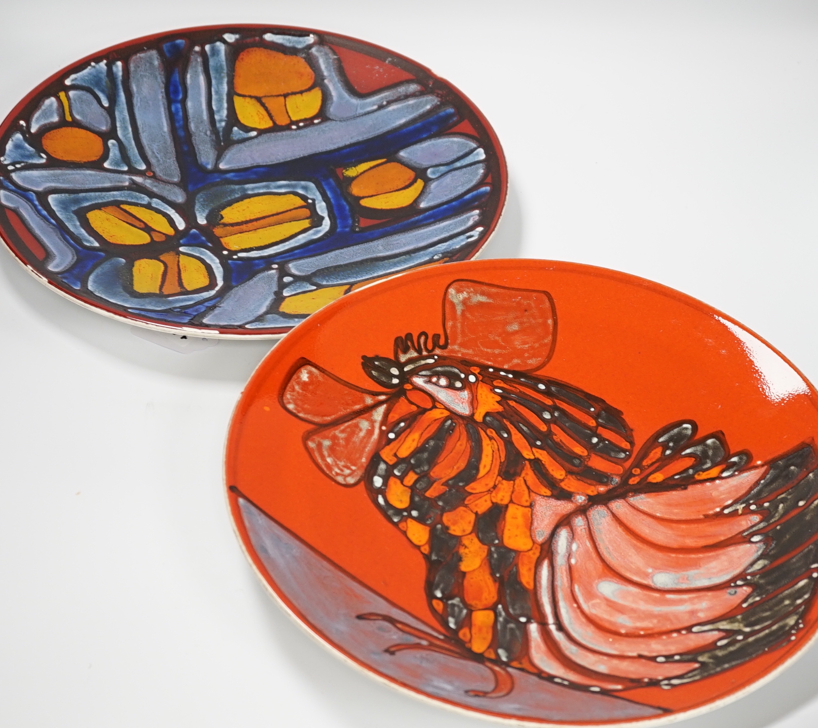 Two Poole Pottery Delphis chargers, one Carol Cutter, the other unsigned, each 36cm in diameter